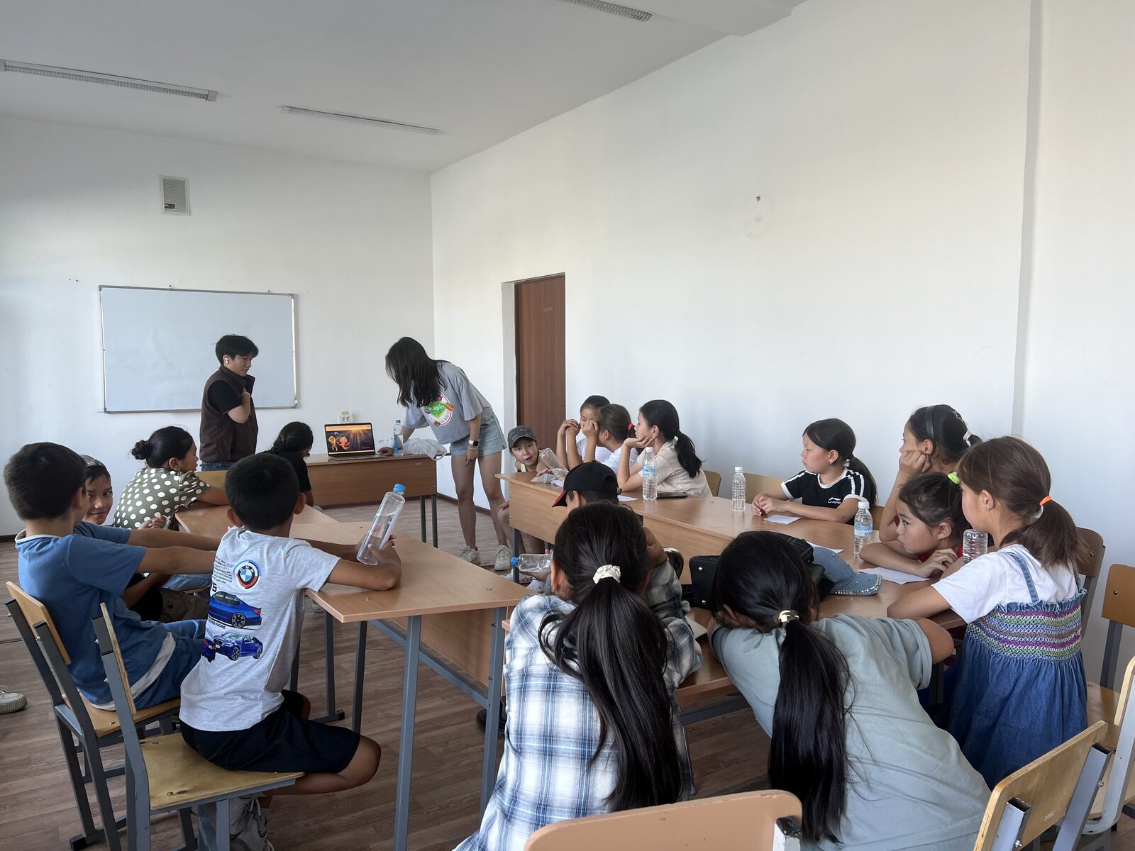 Students in a bright classroom during a climate and ocean lesson
