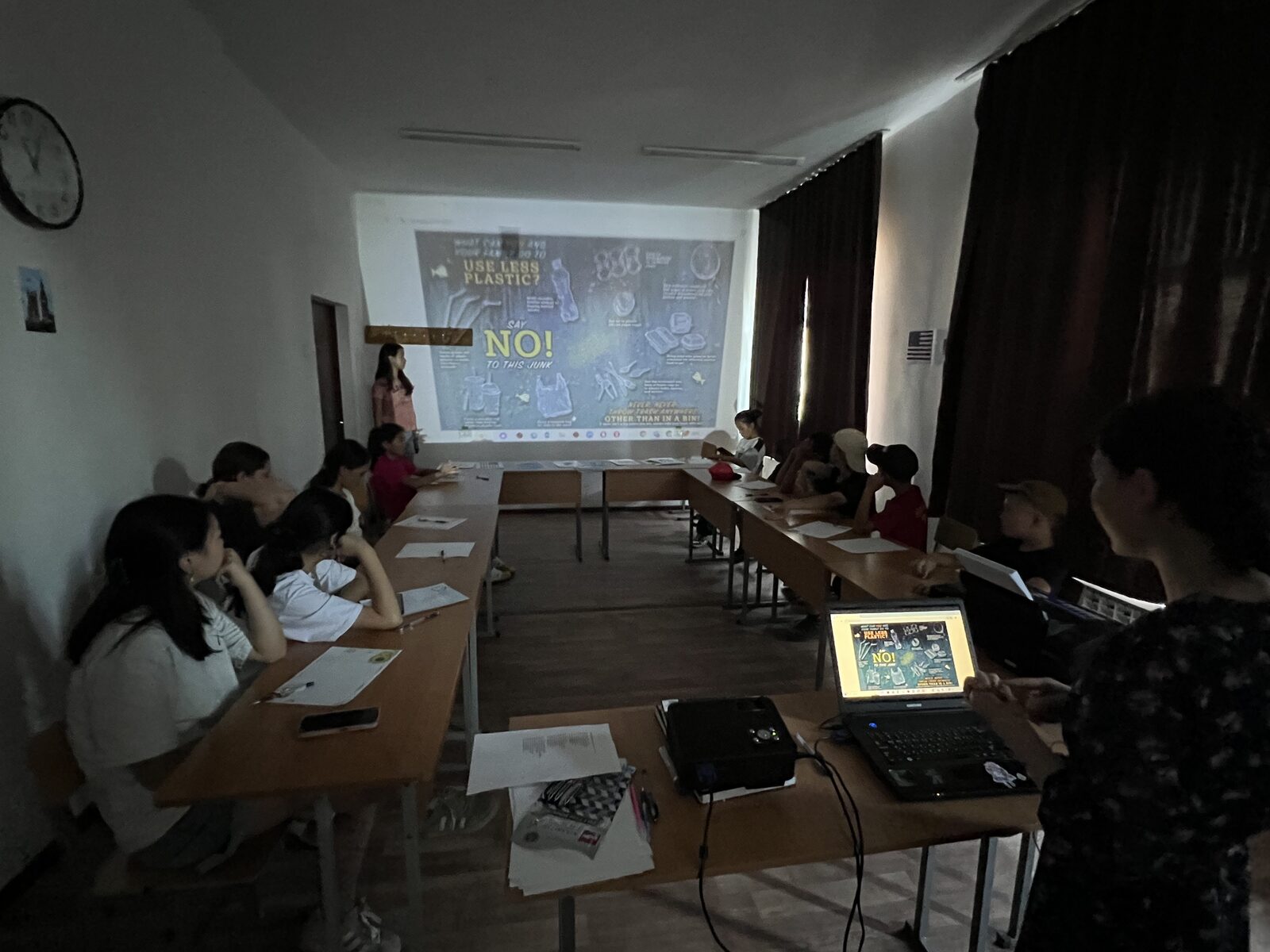 Students in a classroom watching a Use Less Plastic presentation