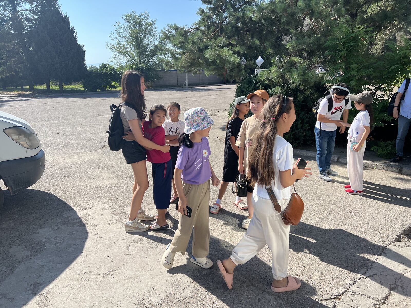 A mentor walking outdoors with a group of kids